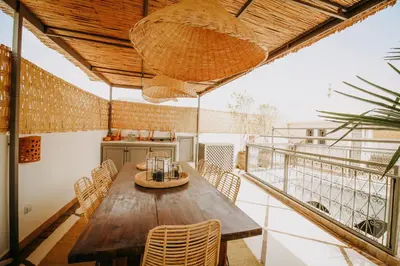 a dining room with a wooden table and chairs at Riad Shabi Kasbah in Marrakech