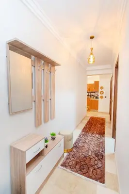 a hallway with a mirror and a rug at Appartement en résidence fermée in Marrakech