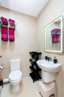 a bathroom with a white toilet and a sink at Appartement en résidence fermée in Marrakech
