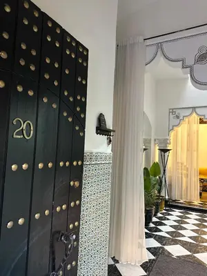 a room with a door and a checkered floor at Riad Nolya Luxury Marrakech - Totalement Rénové - Capacité jusqu à 10 lits spacieux in Marrakech