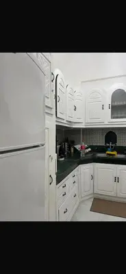 a kitchen with white cabinets and a white refrigerator at Riad Nolya Luxury Marrakech - Totalement Rénové - Capacité jusqu à 10 lits spacieux in Marrakech