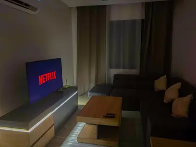 a living room with a couch and a tv at Luxe et Douceur moderne, Parking Privé in Marrakech