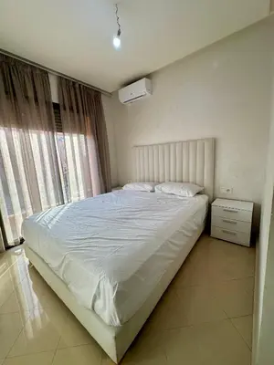 a bedroom with a white bed and a window at Chambre salon à avenue med 6 centre de gueliz 10 in Marrakech
