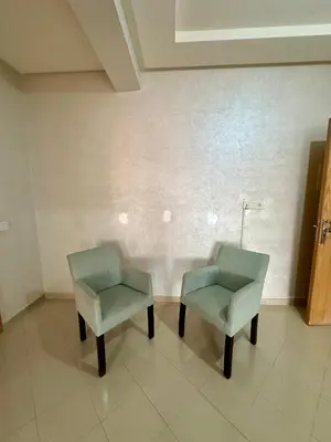 two chairs sitting next to each other in a room at Chambre salon à avenue med 6 centre de gueliz 10 in Marrakech