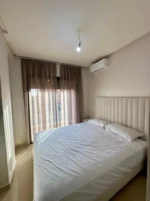 a bedroom with a white bed and a window at Chambre salon à avenue med 6 centre de gueliz 10 in Marrakech