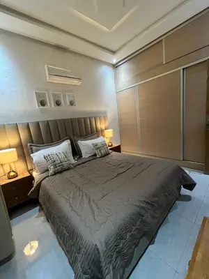 a bedroom with a large bed and two lamps at Dar Amina in Marrakech