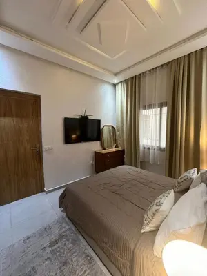 a bedroom with a bed and a tv on the wall at Dar Amina in Marrakech