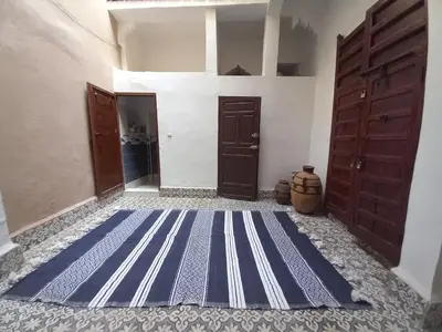 a hallway with a blue and white striped flooring at Juli's in Marrakech