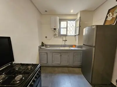 a kitchen with a stainless steel refrigerator and a sink at Guéliz Penthouse in Marrakech