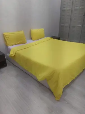 a large yellow bed with two yellow pillows on it at Guéliz Penthouse in Marrakech