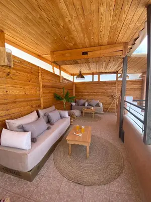 a living room with a couch and a table at Riad DAR OMI ZAHRA in Marrakech