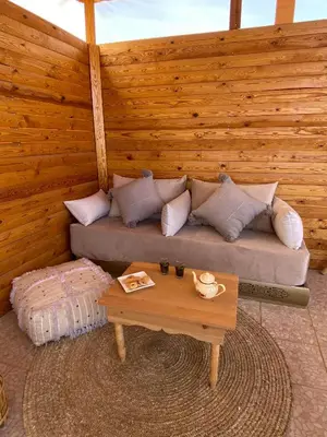 a living room with a couch and a table at Riad DAR OMI ZAHRA in Marrakech