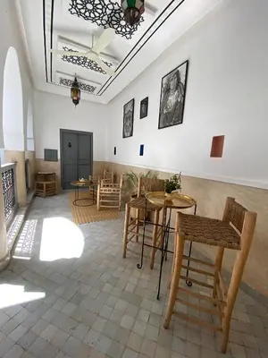a room with tables and chairs and a ceiling at Riad DAR OMI ZAHRA in Marrakech