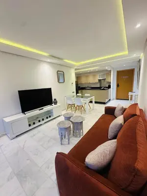 a living room with a couch and a flat screen tv at Spacieux 2 Chambres Guéliz Centre in Marrakech