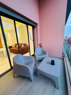 a room with two chairs and a table on a balcony at Spacieux 2 Chambres Guéliz Centre in Marrakech