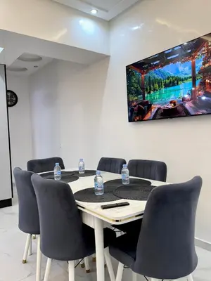 a conference room with a table with chairs and a tv at KSYI IMMO 2 Marrakech Aéroport in Marrakech