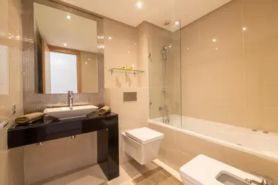 a bathroom with a sink and a toilet and a tub at Relax Front of Panoraview Pool golf Atlas in Marrakech