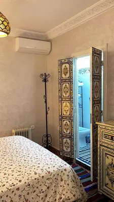 a bedroom with a bed and a large mirror at Raid Maison H in Marrakech