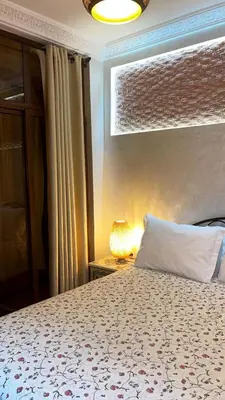 a bedroom with a bed with a pillow and a lamp at Raid Maison H in Marrakech