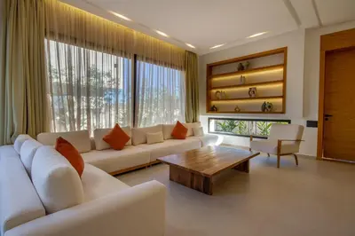 a living room with a white couch and a coffee table at Villa Piscine Privée, Petit déjeuné et ménage inclus in Marrakech