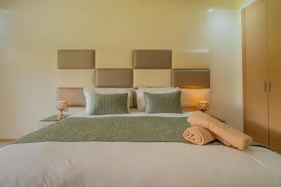 a bedroom with a large bed with two towels on it at Luxury XL Appart Golf View Retreat Private Garden in Marrakech