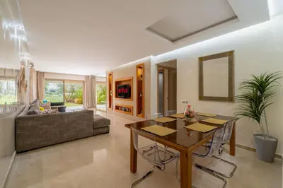 a living room with a table and a couch at Luxury XL Appart Golf View Retreat Private Garden in Marrakech