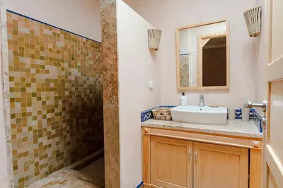 a bathroom with a sink and a shower at Villa Atlas Harmony Marrakech in Marrakech