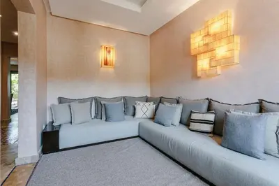 a large couch in a living room with blue pillows at Villa Atlas Harmony Marrakech in Marrakech