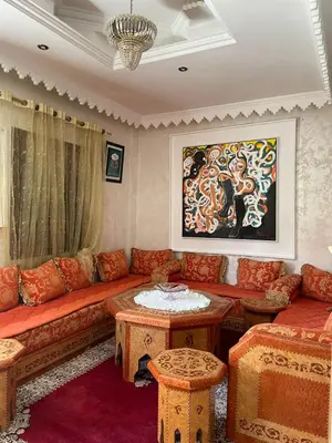 a living room with a couch and a table at Dar Bensoussen in Marrakech