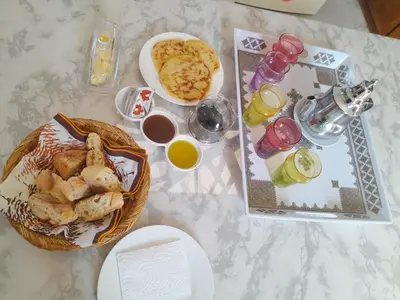 a table topped with a basket of food and drinks at Dar Bensoussen in Marrakech