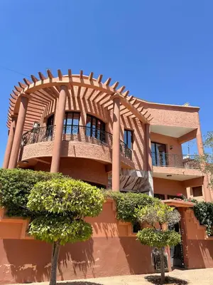 a building with a balcony on the side of it at Dar Bensoussen in Marrakech