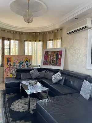 a living room with a couch and a table at Dar Bensoussen in Marrakech