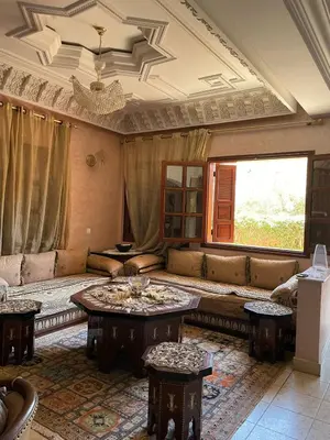 a living room with a couch and a table at Dar Bensoussen in Marrakech