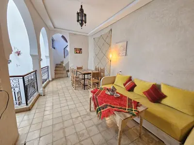 a living room with a couch and a table at Riad Córdoba in Marrakech