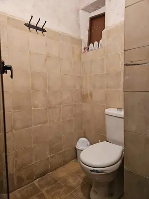 a bathroom with a white toilet in a room at Riad Córdoba in Marrakech