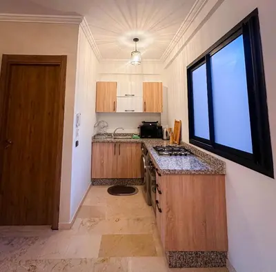 a small kitchen with a sink and a window at Prestigieux Appartement in Marrakech