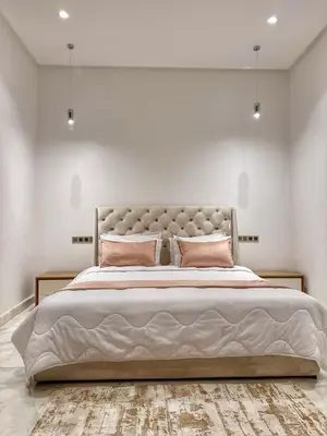 a bedroom with a large bed with pink pillows at villa argan golf piscine chauffée in Marrakech