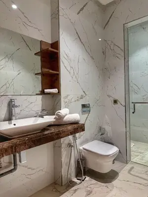 a white bathroom with a sink and a toilet at villa argan golf piscine chauffée in Marrakech