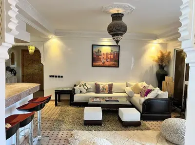 a living room with a couch and a table at Appartement sur Majorelle in Marrakech