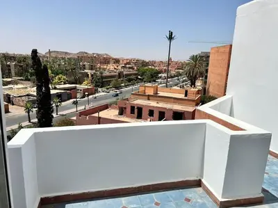 a view of a city from the balcony of a building at Appartement sur Majorelle in Marrakech