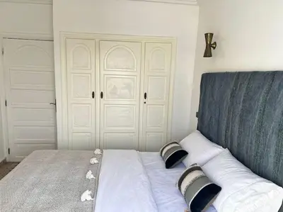 a bed with two pillows on top of it at Appartement sur Majorelle in Marrakech