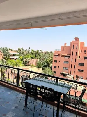 a table on a balcony with a view of a city at Appartement sur Majorelle in Marrakech