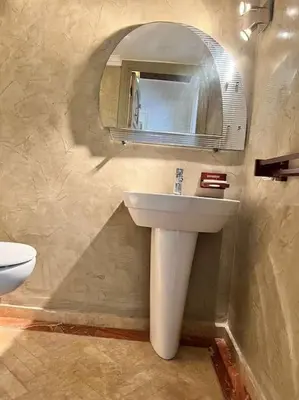 a bathroom with a sink and a mirror at Appartement sur Majorelle in Marrakech