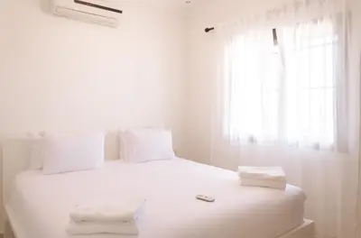 a white bed with white pillows and a window at Designer Gueliz Penthouse - Terrace - Atlas Views in Marrakech
