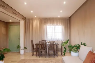 a dining room with a table and chairs at Designer Gueliz Penthouse - Terrace - Atlas Views in Marrakech