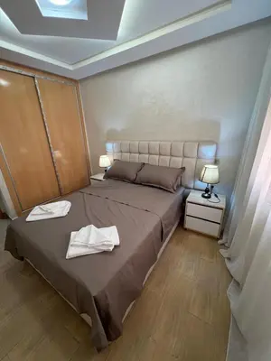 a bedroom with a large bed with two towels on it at Gueliz Luxe Apartment in Marrakech