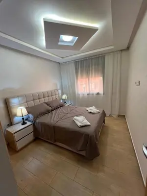 a bedroom with a large bed and a window at Gueliz Luxe Apartment in Marrakech