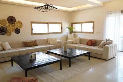 a living room with a couch and a table at Villa Home Orient Avec Piscine Privée 3 Chambres in Marrakech