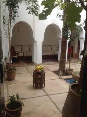 a bowl of fruit sitting in a courtyard at Riad Dar Lalla Fatna in Marrakech