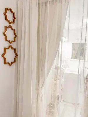 a window with a white curtain next to a window at Studio au coeur de Guéliz in Marrakech
